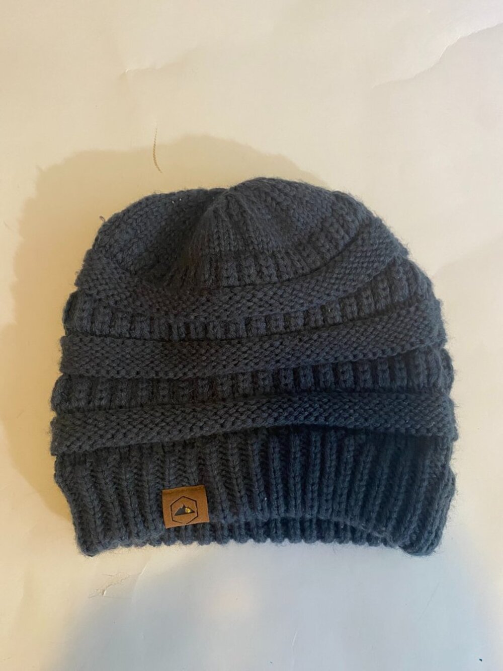 Cozy dark grey knitted beanie hat with a chunky ribbed design by TOUGH